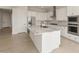 Modern kitchen featuring an island, stainless steel appliances, and white cabinets at 26160 S 225Th Way, Queen Creek, AZ 85142