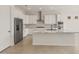Modern white kitchen featuring stainless steel appliances, stone countertops, and an island at 26160 S 225Th Way, Queen Creek, AZ 85142