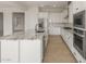 Modern white kitchen featuring stainless appliances and stone countertops at 26160 S 225Th Way, Queen Creek, AZ 85142