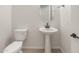 Stylish powder room featuring a pedestal sink, modern faucet, and a decorative oval mirror at 26160 S 225Th Way, Queen Creek, AZ 85142