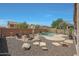 Private backyard with a refreshing pool, fire pit, and ample space for entertaining at 30185 W Flower St, Buckeye, AZ 85396