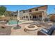 Beautiful backyard with a pool, covered patio, and fire pit, perfect for entertaining and enjoying the outdoors at 30185 W Flower St, Buckeye, AZ 85396