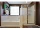 Bathroom featuring a soaking tub, glass shower, and dark walls at 30185 W Flower St, Buckeye, AZ 85396