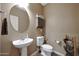 Neat half bathroom featuring a pedestal sink and neutral color scheme for a clean and functional space at 30185 W Flower St, Buckeye, AZ 85396