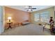 Sunny bedroom with neutral walls, large window, and ample seating with a ceiling fan at 30185 W Flower St, Buckeye, AZ 85396