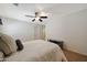 Neutral bedroom featuring a ceiling fan, neutral color walls, and plush bedding at 30185 W Flower St, Buckeye, AZ 85396