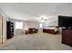 Expansive carpeted bedroom featuring a ceiling fan, sitting area, and a spacious layout at 30185 W Flower St, Buckeye, AZ 85396
