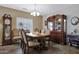 Inviting dining area featuring a chandelier, grandfather clock and a china hutch at 30185 W Flower St, Buckeye, AZ 85396