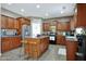 Spacious kitchen featuring an island with breakfast bar, wooden cabinets and stainless steel refrigerator at 30185 W Flower St, Buckeye, AZ 85396