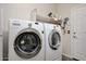 Functional laundry room with side-by-side washer and dryer for efficient home maintenance at 30185 W Flower St, Buckeye, AZ 85396