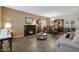 Open-concept living room and dining area featuring a fireplace and tiled floors at 30185 W Flower St, Buckeye, AZ 85396
