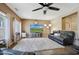 Cozy living room with a large sectional couch, plush rug, and a media center at 30185 W Flower St, Buckeye, AZ 85396