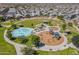 Aerial view of a playground and splash pad with various play structures and a park in a community at 30185 W Flower St, Buckeye, AZ 85396