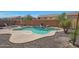 Inviting private pool area with rock landscaping and water feature, perfect for outdoor relaxation and entertaining at 30185 W Flower St, Buckeye, AZ 85396