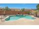 Backyard pool with stone waterfall feature, rock landscaping, and a lush garden at 30185 W Flower St, Buckeye, AZ 85396