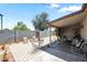 Outdoor patio with covered seating, chairs, and flower bed at 3237 S Albert Ave, Tempe, AZ 85282