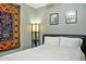 This bedroom includes tile floors, a modern platform bed, and colorful decor at 3237 S Albert Ave, Tempe, AZ 85282