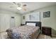 Bedroom with a ceiling fan, light green walls, and a bed with a colorful quilt at 3237 S Albert Ave, Tempe, AZ 85282