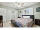 Bedroom with closet and window, showcasing the interior design with a colorful comforter at 3237 S Albert Ave, Tempe, AZ 85282