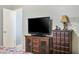 Bedroom featuring a TV on a wooden cabinet and a lamp on a matching dresser at 3237 S Albert Ave, Tempe, AZ 85282