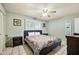 Cozy bedroom with a queen-sized bed, a colorful quilt, and a view of a sunny window at 3237 S Albert Ave, Tempe, AZ 85282