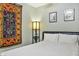 This bedroom includes tile floors, a modern platform bed, and colorful decor at 3237 S Albert Ave, Tempe, AZ 85282