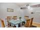 Dining room features a glass table, six wooden chairs, and stylish decor, next to grey walls at 3237 S Albert Ave, Tempe, AZ 85282