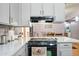 Bright kitchen features white cabinetry, countertops, and black appliances, open floorplan view at 3237 S Albert Ave, Tempe, AZ 85282