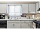 Bright kitchen showcases white cabinetry, modern appliances, and a sleek countertop for meal preparation at 3237 S Albert Ave, Tempe, AZ 85282