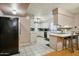 Spacious kitchen features tiled floors, ample cabinetry, and bar seating for casual dining at 3237 S Albert Ave, Tempe, AZ 85282