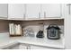 Kitchen counter features appliances, cookbooks, and an open cabinet design at 3237 S Albert Ave, Tempe, AZ 85282