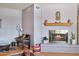 Inviting sitting area featuring a cozy fireplace, decorative accents, neutral paint, and hardwood floors at 3237 S Albert Ave, Tempe, AZ 85282