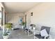 Covered patio with chairs, table, and door to the house at 3237 S Albert Ave, Tempe, AZ 85282