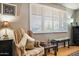 Sitting area featuring a patterned chair, small side table, bench, and natural light from the window at 3237 S Albert Ave, Tempe, AZ 85282