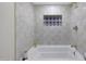 Bright bathroom featuring a tub with tile surround and a decorative tile niche at 3441 N 31St St # 118, Phoenix, AZ 85016