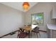 Cozy dining area featuring a wood table, modern chairs, and a view of the lovely outdoor space at 3441 N 31St St # 118, Phoenix, AZ 85016