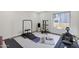 Home gym featuring various exercise equipment, including a rowing machine and weight rack, with natural light at 3441 N 31St St # 118, Phoenix, AZ 85016