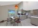 Open kitchen and dining area with stainless steel appliances, bright cabinets, and poolside view at 3441 N 31St St # 118, Phoenix, AZ 85016