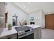 Bright kitchen with quartz countertops and access to the living space with fireplace and TV at 3441 N 31St St # 118, Phoenix, AZ 85016
