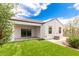 A backyard featuring artificial turf, covered patio, and privacy fencing at 3480 N 307Th Dr, Buckeye, AZ 85396