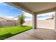 View of covered patio and green backyard with block wall at 3480 N 307Th Dr, Buckeye, AZ 85396