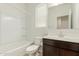 Bright bathroom featuring a shower-tub combo and a dark wood vanity with a mirror at 3480 N 307Th Dr, Buckeye, AZ 85396