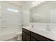 Bright bathroom featuring a double sink vanity and a shower-tub combination at 3480 N 307Th Dr, Buckeye, AZ 85396