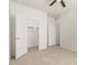 Bright bedroom features neutral carpet, a ceiling fan, and a walk-in closet for ample storage at 3480 N 307Th Dr, Buckeye, AZ 85396