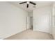 Bright carpeted bedroom featuring closet with sliding doors and an open door to additional space at 3480 N 307Th Dr, Buckeye, AZ 85396