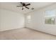 Bright bedroom with neutral carpet, a ceiling fan, and two windows for ample natural light at 3480 N 307Th Dr, Buckeye, AZ 85396