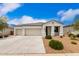 Charming single-story home with a three-car garage and low-maintenance desert landscaping at 3480 N 307Th Dr, Buckeye, AZ 85396