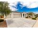 Exterior of home featuring a three-car garage and desert landscaping at 3480 N 307Th Dr, Buckeye, AZ 85396