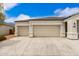 Exterior view of the home's three-car garage and long driveway at 3480 N 307Th Dr, Buckeye, AZ 85396