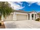 View of the three-car garage and driveway at 3480 N 307Th Dr, Buckeye, AZ 85396